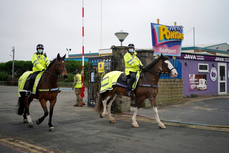 Mounted policde officers leave Pontins camp to exercise their horses as members of the military arrive at Pontins. Getty Images