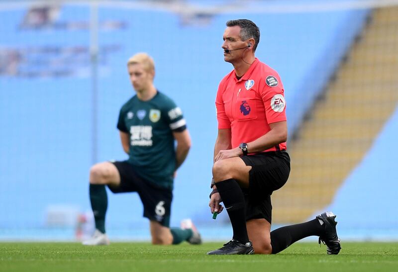 Referee Andre Marriner and Burnley captain kneel in support of the Black Lives Matter campaign. Reuters