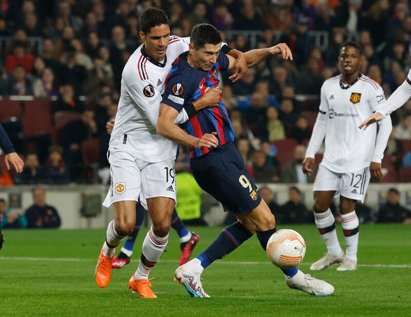 United's Raphael Varane in action with Barcelona's Robert Lewandowski. Reuters