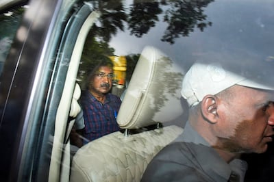 Arvind Kejriwal, left, leader of the Aam Admi Party, leaves a court hearing in New Delhi. AP