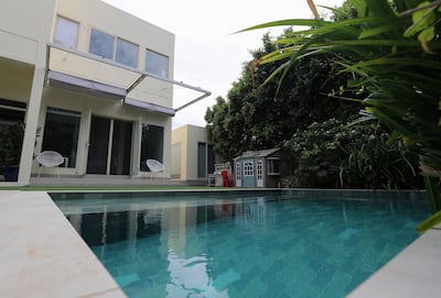 The garden has its own private pool, while the community also has a communal swimming pool. Chris Whiteoak / The National