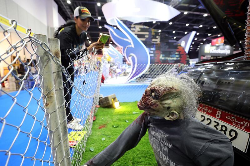 Dubai, United Arab Emirates - April 11, 2019: Asma Amer takes a pic of a zombie at the Middle East Film and Comic Con. Thursday the 11th of April 2019. World Trade Centre, Dubai. Chris Whiteoak / The National