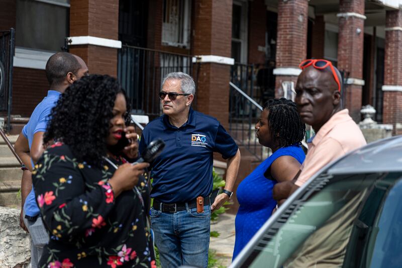District Attorney Larry Krasner and other officials walk through the neighbourhood the morning after the mass shooting. AP