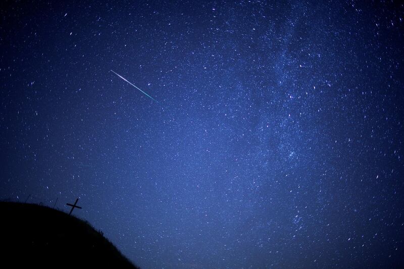 A meteor streaks past the Milky Way in the night sky above Leeberg hill during the Perseid meteor shower in Grossmugl, Austria. Reuters