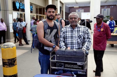 Ahmed Khalid, left, with his father after arriving at Jomo Kenyatta International Airport in Nairobi. Reuters