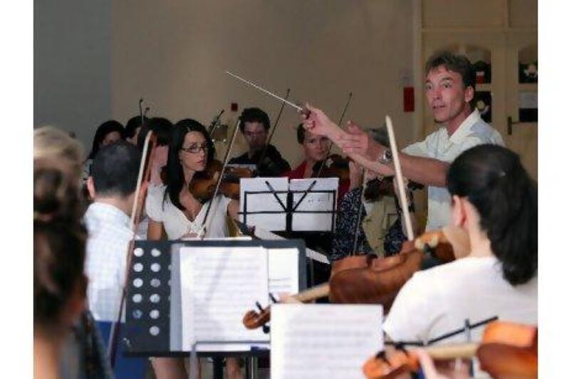 Philipp Maier, shown conducting a rehearsal of the UAE Philharmonic Orchestra, writes in a letter to the editor that the UAE does not have enough musicians for two symphony orchestras. Randi Sokoloff for The National