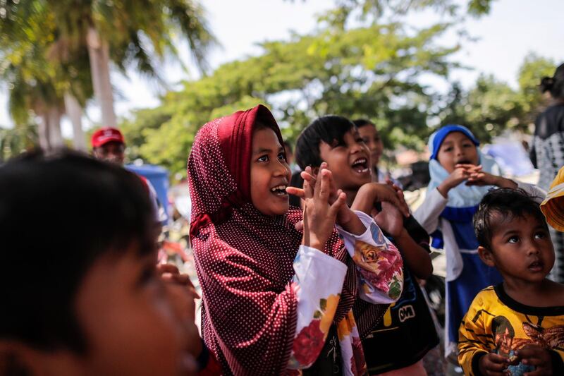 Children sing during a trauma healing class at a temporary shelter outside the grand mosque in Palu. EPA