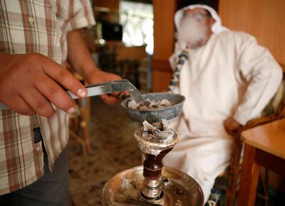 ABU DHABI, UNITED ARAB EMIRATES Ð March 18, 2008: Suleman Ali smokes Shisha in an Abu Dhabi Cafe. (Photo by Ryan Carter / The Nation)
 *** Local Caption *** OP6Letters.jpg