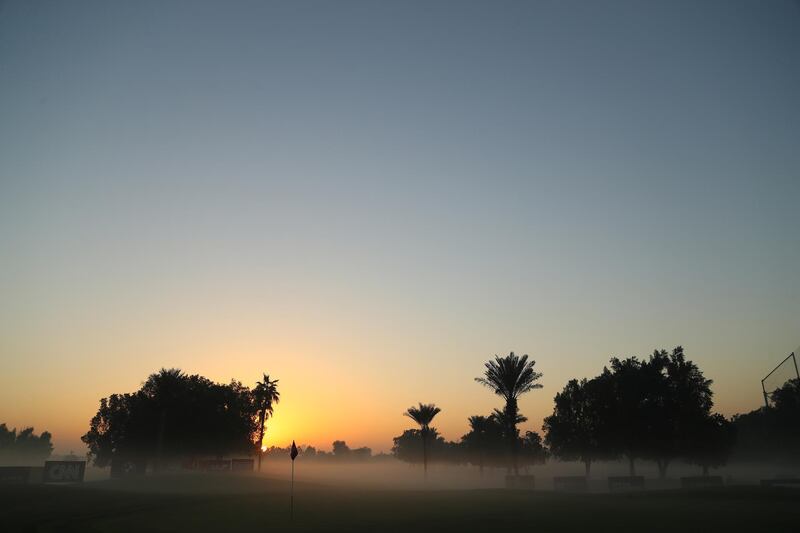 Fog engulfs the 17th green at the Emirates Golf Club. Getty