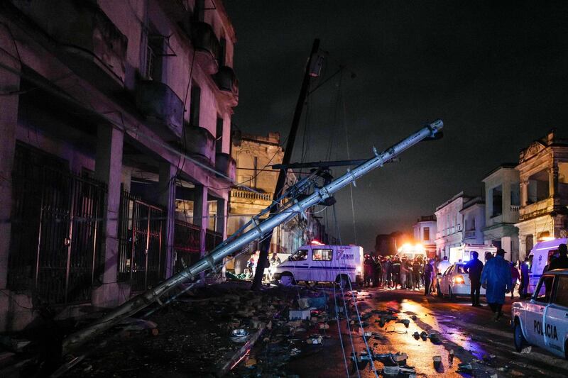 A fallen utility pole is seen among debris in the tornado-hit Luyano neighbourhood in Havana early on January 28, 2019.  AFP
