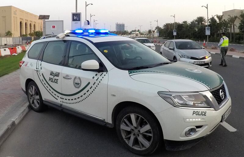 DUBAI, UNITED ARAB EMIRATES , April 16– 2020 :- Dubai Police officer stopping the private vehicles and checking the movement permit near Madinat Jumeirah in Dubai. Dubai is conducting 24 hours sterilisation programme across all areas and communities in the Emirate and told residents to stay at home. UAE government told residents to wear face mask and gloves all the times outside the home whether they are showing symptoms of Covid-19 or not.  (Pawan Singh / The National) For News/Online/Instagram