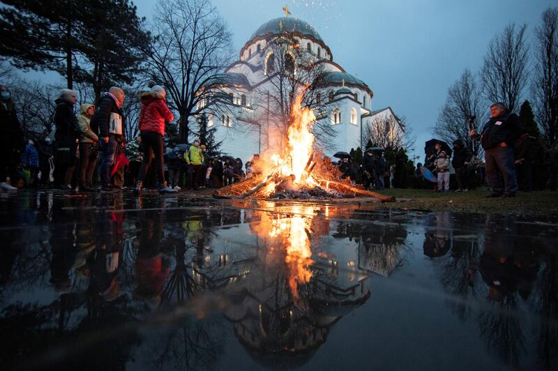 Believers burn dried oak branches, which symbolise the Yule log, on Orthodox Christmas Eve in front of the Saint Sava temple in Belgrade, Serbia. Reuters