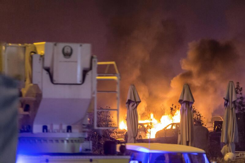 DUBAI. UNITED ARAB EMIRATES, 04 AUGUST 2017. A massive fire rips through The Marina Torch tower's southern corner. Cars burn in an adjacent informal parking lot due to the flaming debris falling from the building. (Photo: Antonie Robertson) Journalist: None. Section: National.