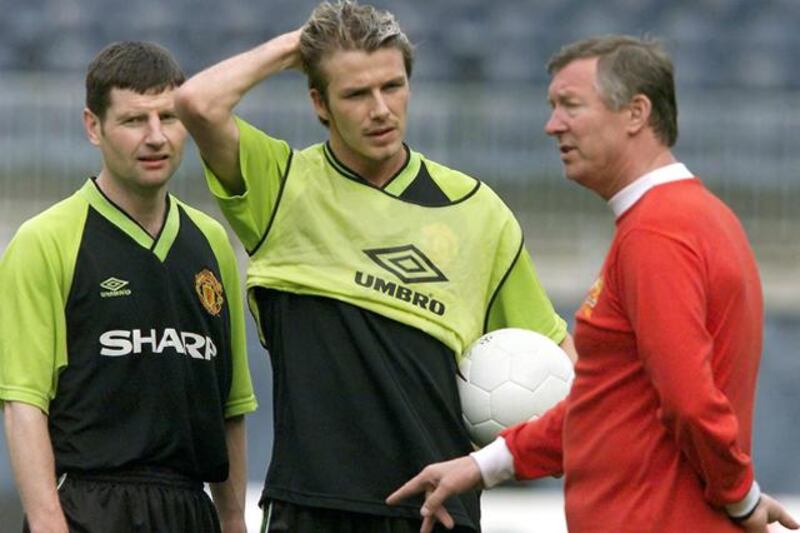 (FILES) In a file picture taken on May 25, 1999 Manchester United's manager Alex Ferguson (R) talks to midfielder David Beckham (C) and defender Denis Irwin (L) during the team's practice at the Camp Nou Stadium in Barcelona, on the eve of the UEFA Champions League final football match between the English champions Manchester United and the German champions Bayern Munich. David Beckham is to retire from professional football at the end of the season, his representative announced on on May 16, 2013. The 38-year-old midfielder has played for Manchester United, Real Madrid and AC Milan, as well as winning 115 caps for England, and recently won the French Ligue 1 championship with Paris Saint-Germain.  AFP PHOTO / PATRICK HERTZOG

