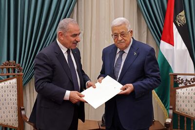 Former prime minister Mohammad Shtayyeh presents the resignation of his government to President Mahmoud Abbas in Ramallah on Monday. AFP