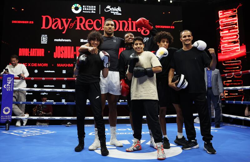 Anthony Joshua poses for a photo with children from a Riyadh boxing club. Getty