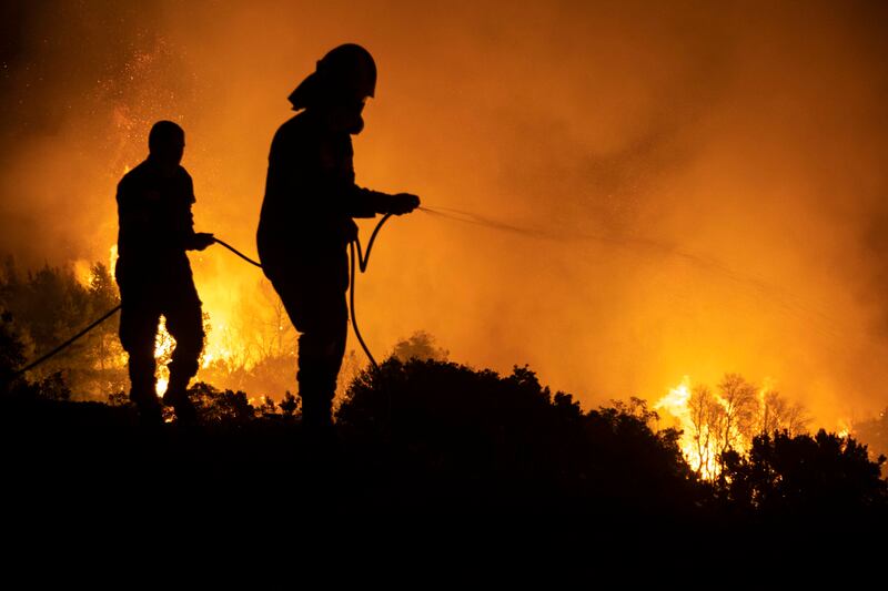 Firefighters tackle wildfires, in Evia, Greece, thought by many experts to have been fuelled by climate change. Getty Images