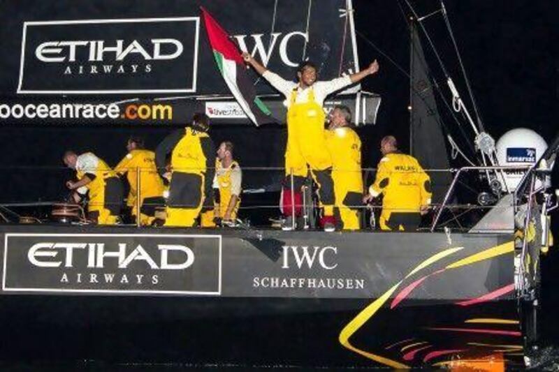 Emirati sailor Adil Khalid waves the UAE flag.