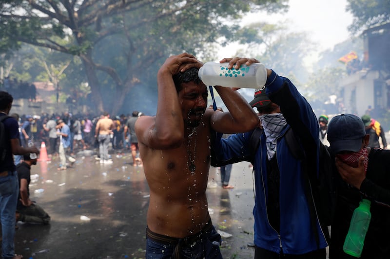 A protester pours water on a man as tensions soar. Reuters