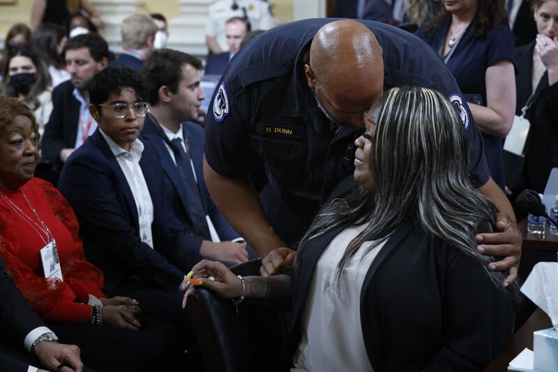 US Capitol Police Officer Harry Dunn hugs Wandrea “Shaye” Moss, a former Georgia election worker, after she testified during the fourth hearing on the January 6 investigation. Getty / AFP
