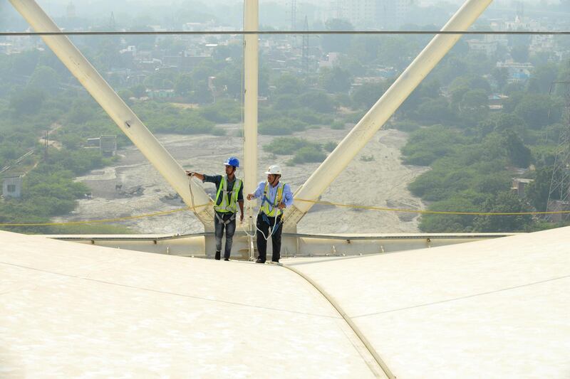 A safety officer oversees construction work at the Motera stadium. AFP