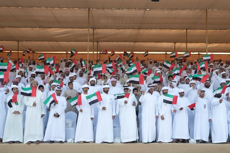 ZAYED MILITARY CITY, ABU DHABI, UNITED ARAB EMIRATES - November 28, 2017: Guests and family members watch the parade during the graduation ceremony of the 8th cohort of National Service recruits and the 6th cohort of National Service volunteers at Zayed Military City. 

( Boris Dejanovic for the Crown Prince Court - Abu Dhabi  )
---