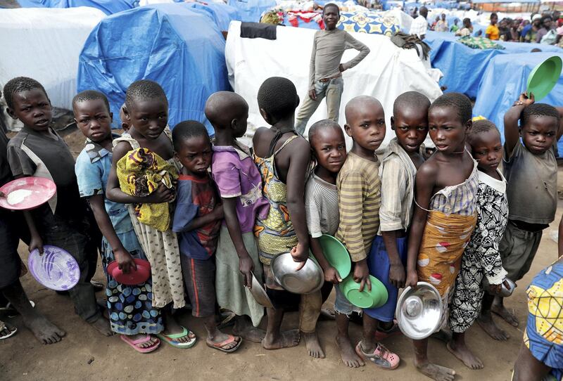 Internally displaced children wait for food distribution at an internally displaced persons (IDP) camp in Bunia, Ituri province, eastern Democratic Republic of Congo, April 12, 2018. REUTERS/Goran Tomasevic