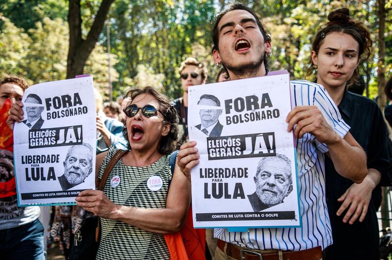 epa07788148 French ecologist activists and environmental protection groups shout slogans against Brazilian President Bolsonaro, as they gather in a protest in front of the Brazilian embassy in Paris, France, 23 August 2019. Protesters claim Bolsonaro is responsible of the deforestation that causes huge fires in the Amazonian forest.  EPA/CHRISTOPHE PETIT TESSON