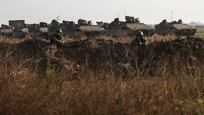 Israeli soldiers secure tanks and military vehicles near the border with the Gaza Strip, on Saturday.  Reuters