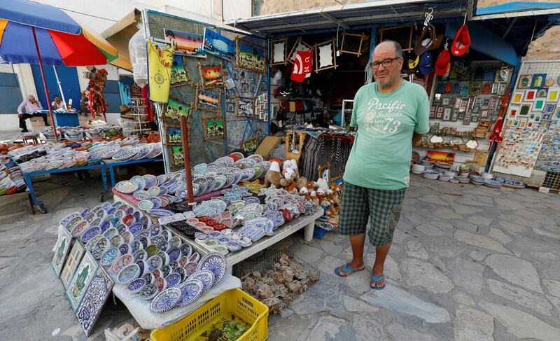 Ridha, a shopkeeper, waits for customers in front of a souvenir shop following Thomas Cook's collapse, in Hammamet, Tunisia. Reuters