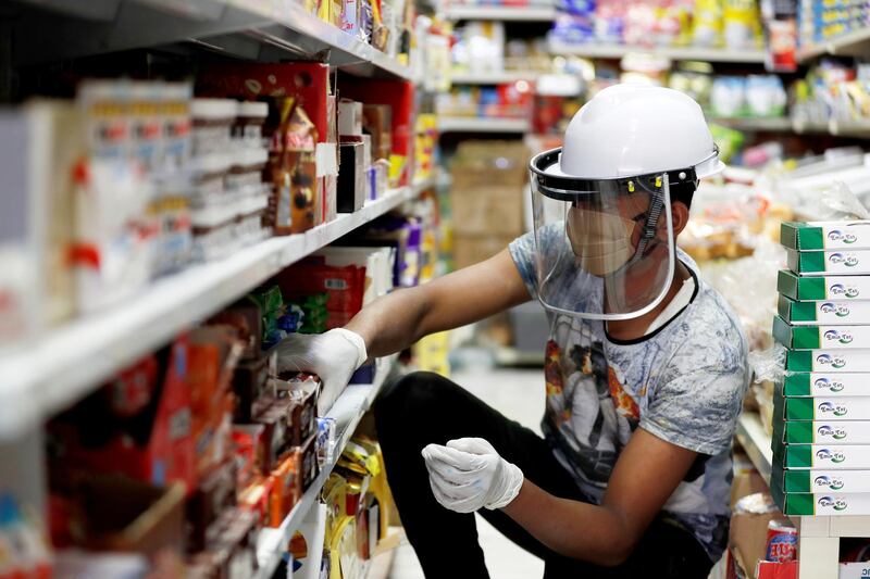 A worker wears a protective face shield at a store in Baghdad, Iraq. Reuters