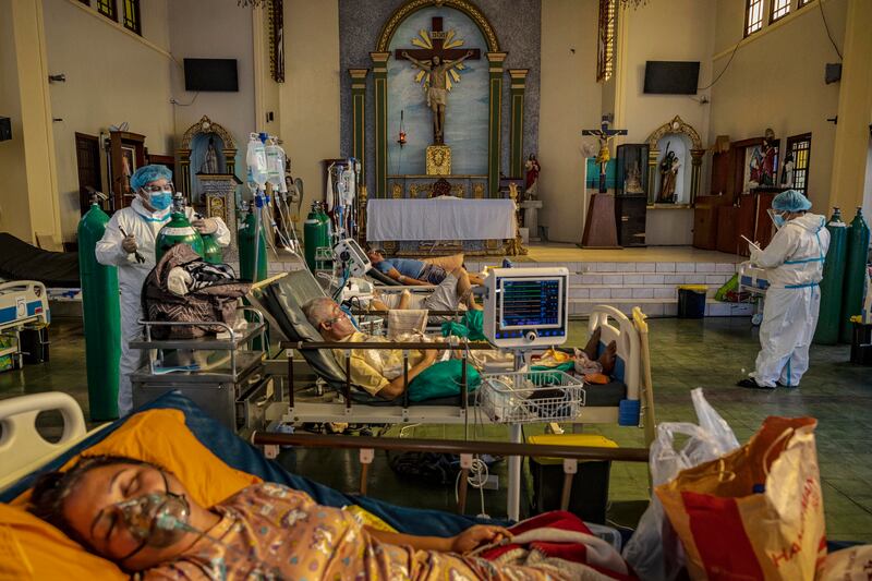 Medics treat patients infected with Covid-19 at a chapel converted into an intensive care unit on August 25 in Manila, the Philippines. Getty
