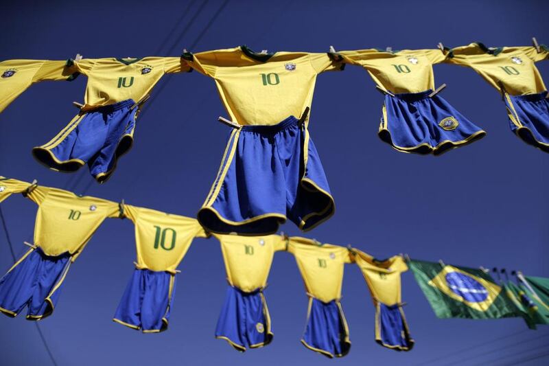 Replicas of the Brazilian national football team jerseys are displayed for sale on a street in Brasilia. Ueslei Marcelino / Reuters