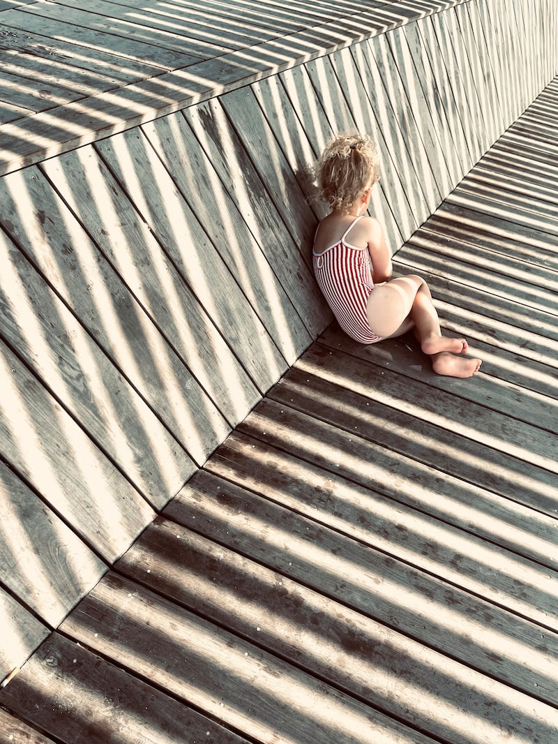 Children, Third Place, 'In the Shade of the Stripes', shot in Carnac, France by Anne Ziolo on iPhone 12 Pro Max. Photo: Anne Ziolo / IPPAWARDS