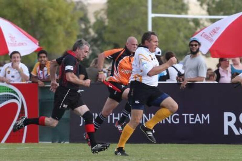 Dubai, United Arab Emirates, Dec 1 2011, Dubai Hurricanes vets v Sharjah Fat Boys,Sports Reporter Paul Radley Story- (centre white kit) Sharjah fat Boy Andy Hall chases down a kick and run   during action at the Seven's Tournament. Mike Young / The National