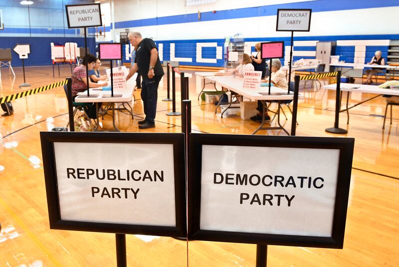 A voter arrives at Suffield Middle School in Connecticut on primary election day. AP