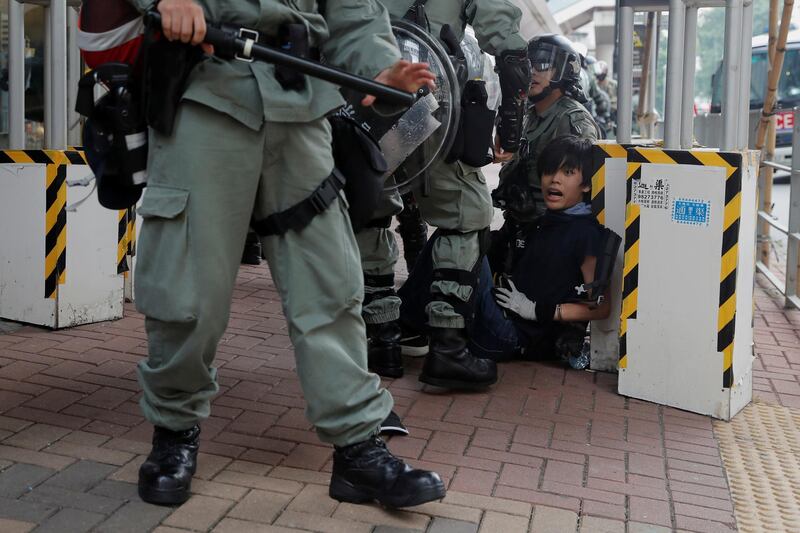 Riot police officers detain an anti-government protester in Tsuen Wan, near the site where police shot a protester with live ammunition on China's National Day in Hong Kong, China October 13, 2019. REUTERS/Susana Vera