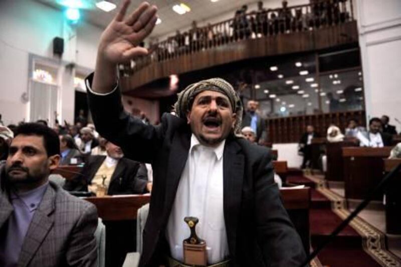 epa03070708 A member of the Yemeni parliament debates a law granting immunity to outgoing Yemeni President Ali Abdullah Saleh and his close aides at the headquarters of the parliament in Sana'a, Yemen, 21 January 2012. According to media sources, the Yemeni parliament approved a law granting outgoing Yemeni President Saleh and his close aides immunity from prosecution in return for stepping down from power.  EPA/YAHYA ARHAB *** Local Caption ***  03070708.jpg