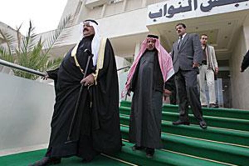 The Jordanian MP Hamad Abouzeid, left, leaves the parliament building in Amman after the dissolution of parliament.