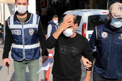 Syrian singer Omar Souleyman escorted by Turkish policemen as he leaves hospital in Sanliurfa on November 18, 2021, a day after he was arrested. AFP