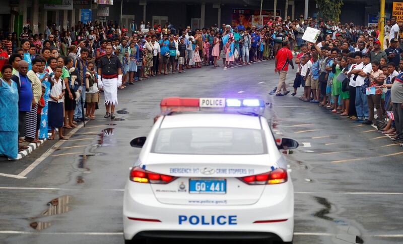 A police vehicle is seen as crowds line the streets in Suva, Fiji. Reuters