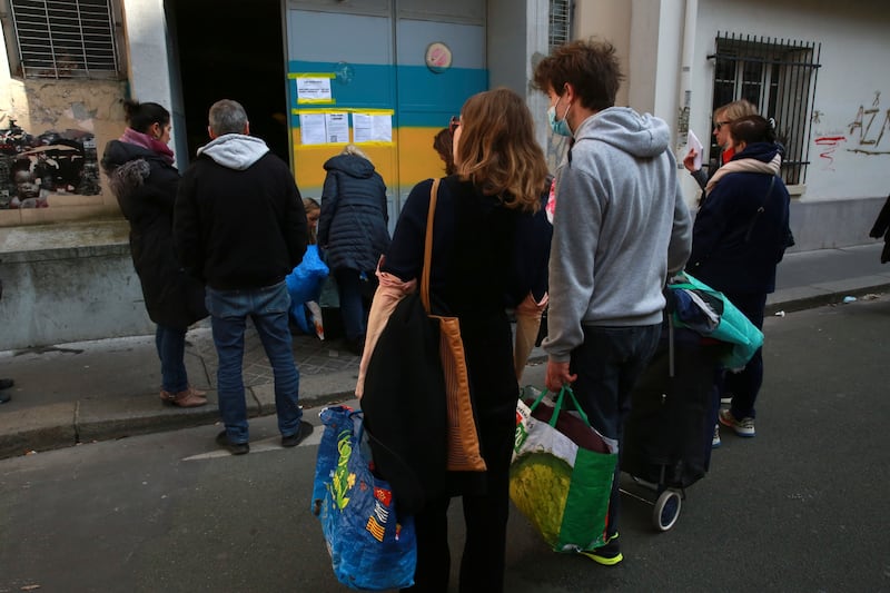 People queue to drop supplies in a depot belonging to the Ukrainian scout association in Paris. AP