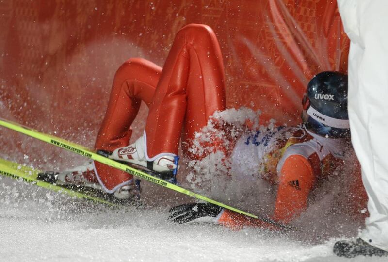 Russia's Dmitry Vassiliev crashes into the padded barrier after his first attempt during the ski jumping large hill final in Krasnaya Polyana on Saturday. Gregorio Borgia / AP