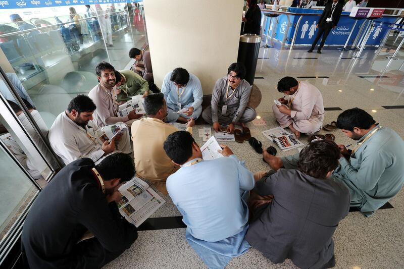Dubai, United Arab Emirates - March 17, 2019: People study the form and mark their race cards at the Dubai World Cup. Saturday the 30th of March 2019 at Meydan Racecourse, Dubai. Chris Whiteoak / The National