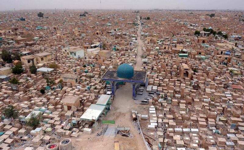 A photograph taken on February 19, 2020, shows a view of the Wadi al-Salam ("Valley of Peace") cemetery in the Iraqi Shiite holy city of Najaf, where Iraqi paramilitary commander Abu Mahdi al-Muhandis was buried. Al-Muhandis was killed alongside a top Iranian general in a US drone strike in Baghdad on January 3, and his final resting place in the world's largest cemetery has gained near-holy status, becoming an anti-US magnet and a stop for thousands of Shiite pilgrims who pass through Najaf each day to visit the tomb of Imam Ali, son-in-law of the Prophet Mohammed. / AFP / Haidar HAMDANI
