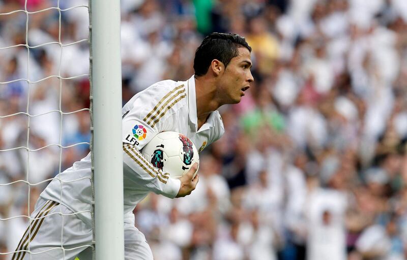 MADRID, SPAIN - MAY 13: Cristiano Ronaldo of Real Madrid holds the ball after scoring during the La Liga match between Real Madrid CF and RCD Mallorca at Estadio Santiago Bernabeu on May 13, 2012 in Madrid, Spain. (Photo by Elisa Estrada/Real Madrid via Getty Images)