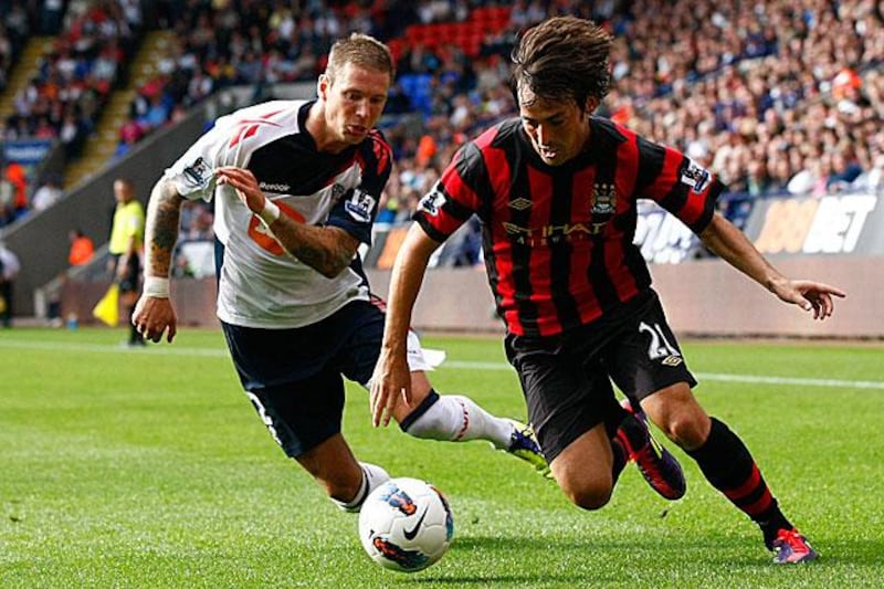 David Silva, right, dribbles past the Bolton defender Gretar Steinsson during Manchester City's 3-2 win at the Reebok Stadium.

Tim Hales / AP photo