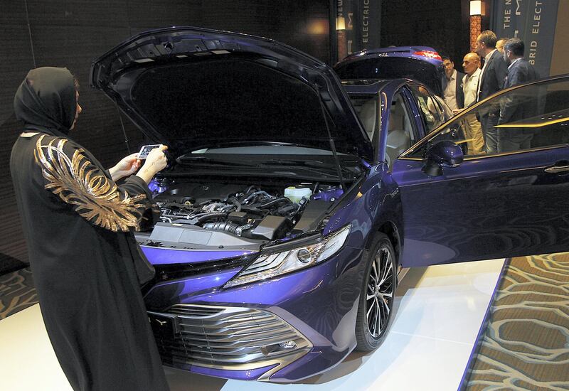 Dubai, June, 03, 2018:  Visitor takes a photo of the  new Toyota Camry HEV ( HYBRID ) which was unveiled for the first time in the UAE in Dubai. Satish Kumar for the National / Story by Adam Workman