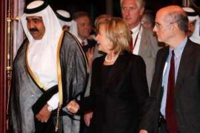 US Secretary of State Hillary Clinton speaks with Qatari Emir Sheikh Hamad bin Khalifah al-thani (L) upon arrival to attend the seventh edition of the US-Islamic World Forum in Doha on February 14, 2010. Clinton said in her speech at the forum that Washington was "disappointed" with the lack of a breakthrough in the Middle East peace process, but stressed solutions cannot be forced. AFP PHOTO/KARIM JAAFAR *** Local Caption ***  854872-01-08.jpg