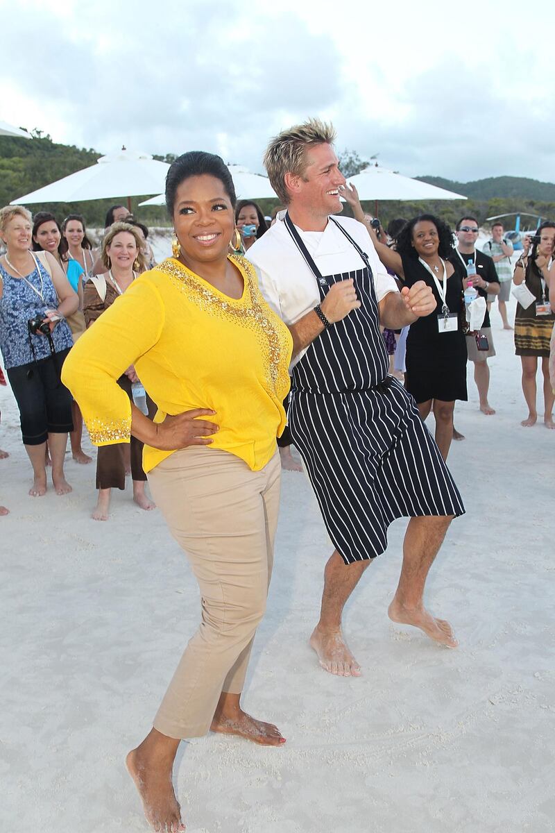 HAMILTON ISLAND, AUSTRALIA - DECEMBER 08:  In this handout image provided by Harpo Productions Inc., Oprah Winfrey dances with Chef Curtis Stone  on December 8, 2010 on Hamilton Island, Australia. Oprah Winfrey is in Australia with 302 audience members from the US, Canada and Jamaica and will tape episodes of the 25th and final season of 'The Oprah Winfrey Show' from the Sydney Opera house next week. The shows will air in the US and Australia in January 2011. (Photo by George Burns/Harpo Productions Inc. via Getty Images)